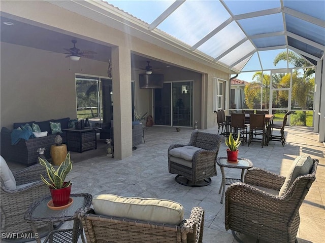 view of patio / terrace with outdoor dining space, a ceiling fan, and outdoor lounge area