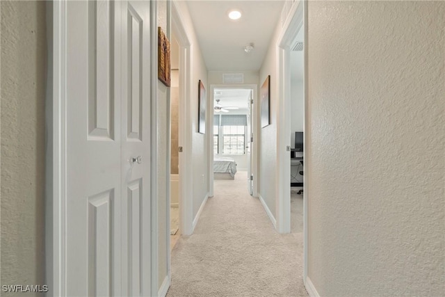 14127 Oviedo Pl, Fort Myers, FL 33905 - hallway with light carpet, a textured wall, and baseboards