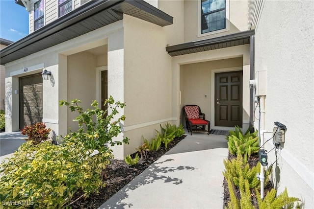 14127 Oviedo Pl, Fort Myers, FL 33905 - property entrance featuring a garage and stucco siding