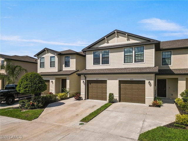 multi unit property featuring an attached garage, a shingled roof, concrete driveway, and stucco siding