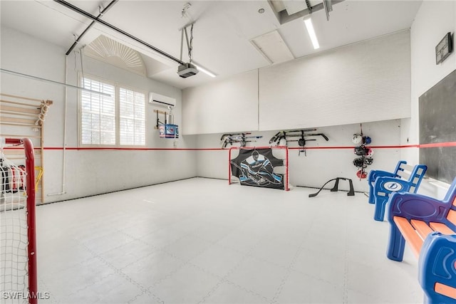 garage with a garage door opener and a wall mounted AC