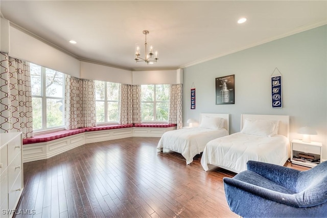 bedroom with ornamental molding, multiple windows, and wood finished floors