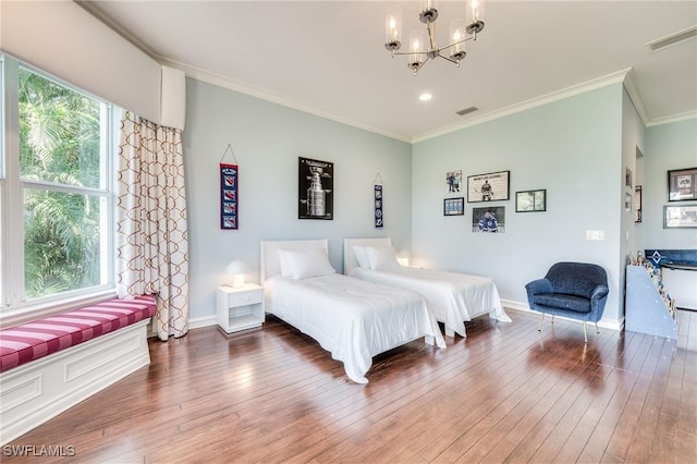 bedroom with baseboards, wood-type flooring, an inviting chandelier, and crown molding