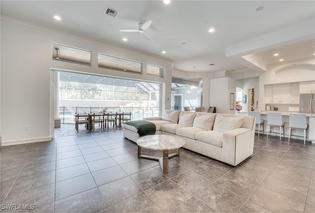 living room with ornamental molding, recessed lighting, visible vents, and a ceiling fan