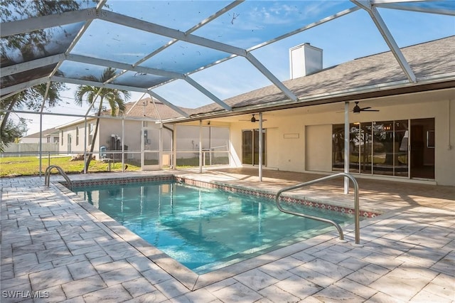 pool with a patio, a lanai, and a ceiling fan