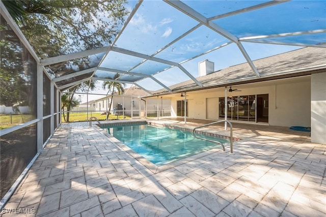 outdoor pool featuring a lanai, a patio area, and a ceiling fan