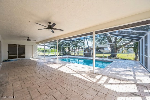 pool featuring a ceiling fan, a lanai, and a patio area