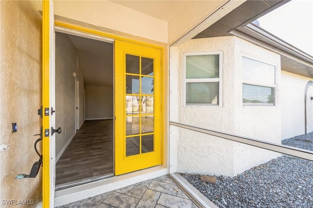 view of exterior entry featuring stucco siding