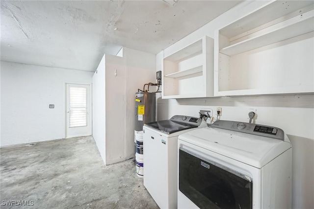 washroom with laundry area, electric water heater, and washer and dryer