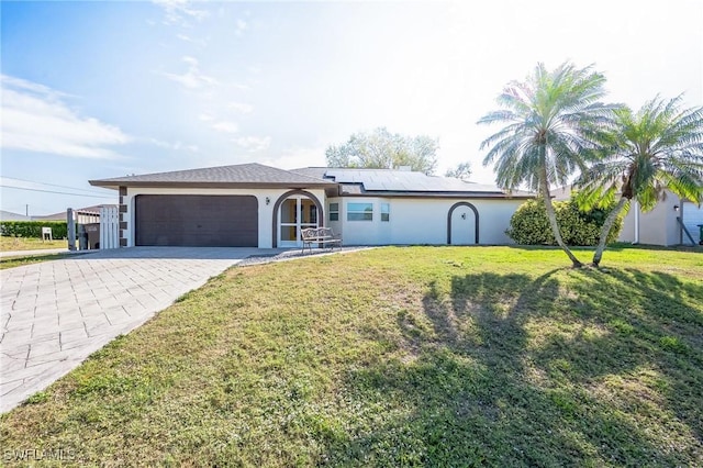 ranch-style house featuring an attached garage, driveway, a front lawn, and stucco siding