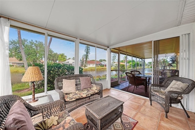 sunroom / solarium featuring a water view