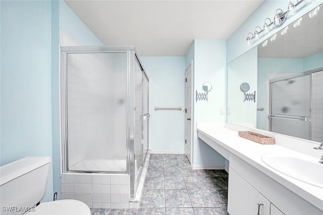 full bathroom featuring baseboards, a shower stall, toilet, and vanity