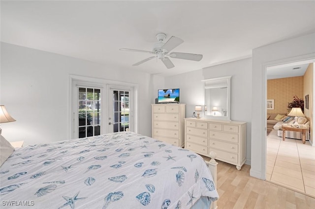 bedroom featuring access to outside, french doors, ceiling fan, and light wood-style flooring