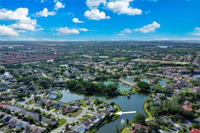 birds eye view of property with a water view and a residential view