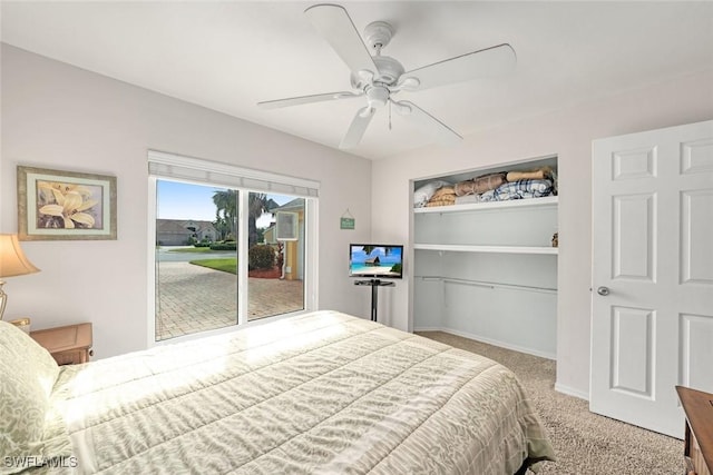 carpeted bedroom with a ceiling fan, a closet, and baseboards