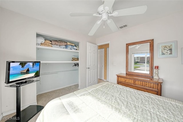 carpeted bedroom with a closet, visible vents, ceiling fan, and baseboards