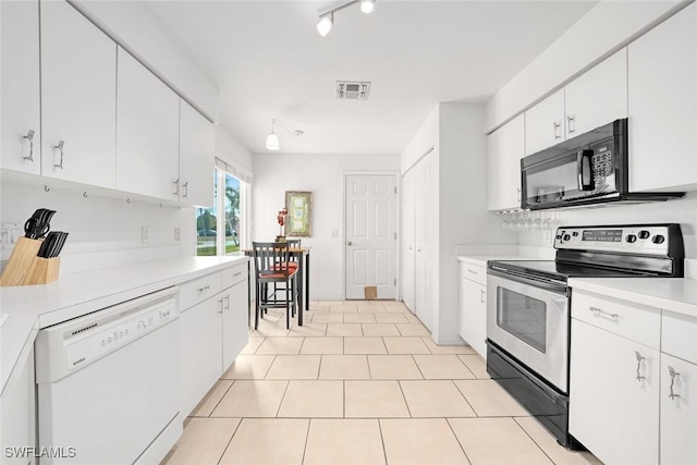 kitchen featuring visible vents, dishwasher, stainless steel electric range oven, light countertops, and black microwave