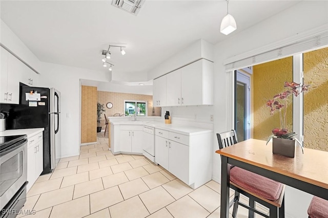 kitchen featuring a peninsula, visible vents, stainless steel range with electric cooktop, light countertops, and dishwasher