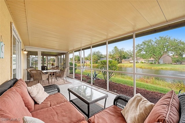 sunroom featuring a water view and wood ceiling