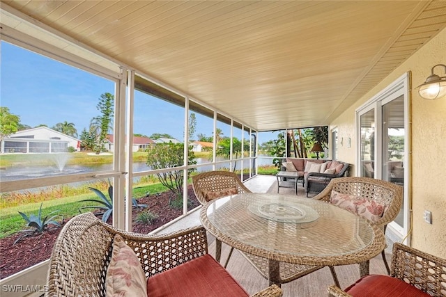 sunroom with a water view and wooden ceiling