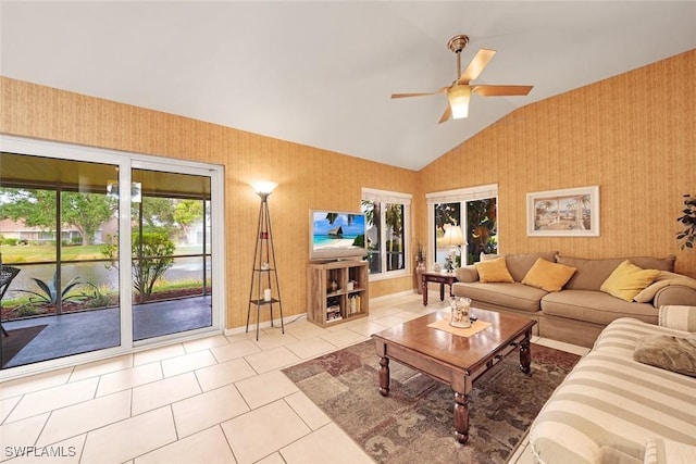 living room featuring tile patterned flooring, ceiling fan, lofted ceiling, and wallpapered walls