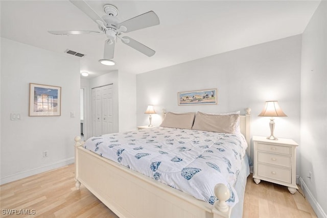 bedroom with ceiling fan, visible vents, baseboards, a closet, and light wood-type flooring