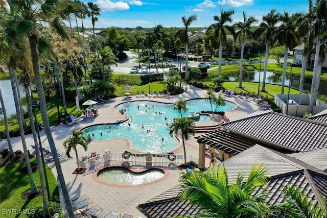 community pool with a patio and a water view