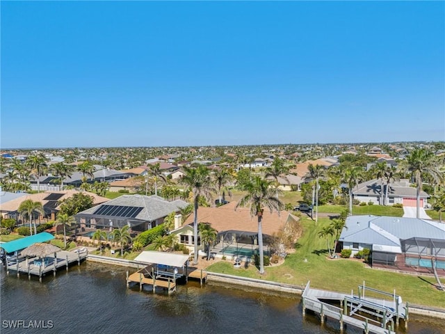 drone / aerial view with a water view and a residential view