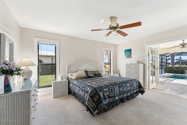 bedroom featuring access to outside, a sunroom, light colored carpet, and ceiling fan