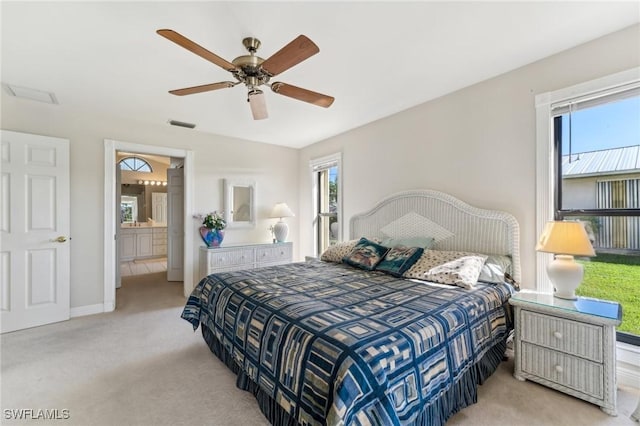 bedroom featuring light colored carpet, ceiling fan, visible vents, and baseboards