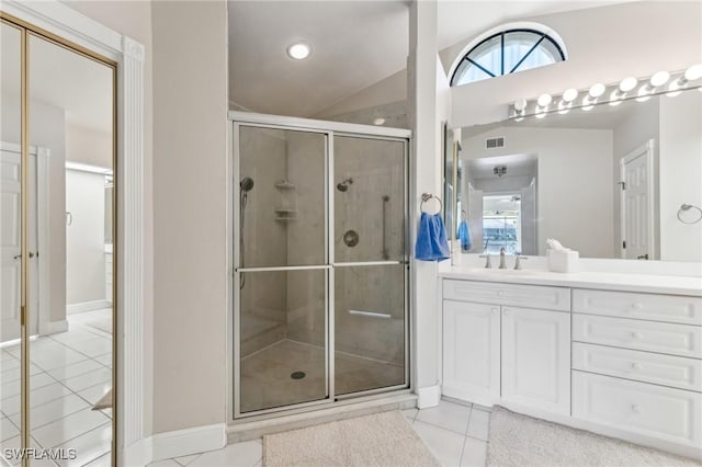 bathroom featuring a stall shower, visible vents, lofted ceiling, tile patterned flooring, and vanity