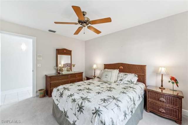 bedroom with light carpet, ceiling fan, and visible vents