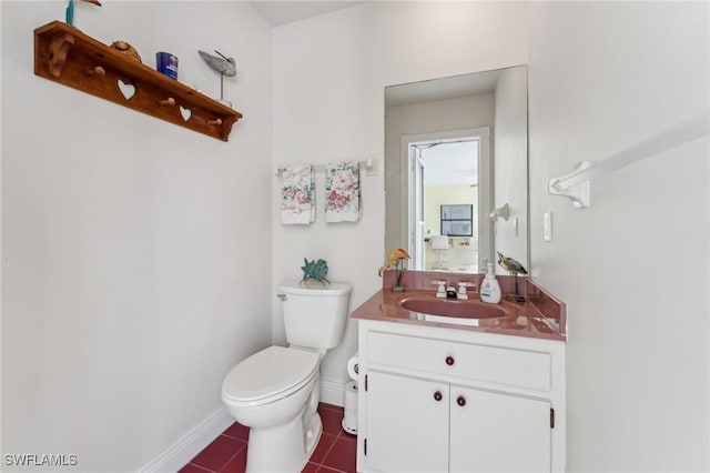 bathroom with vanity, tile patterned floors, toilet, and baseboards