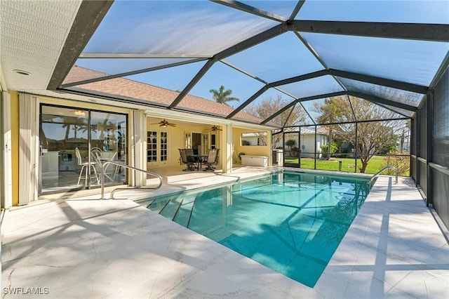 pool with a patio, a lanai, and a ceiling fan