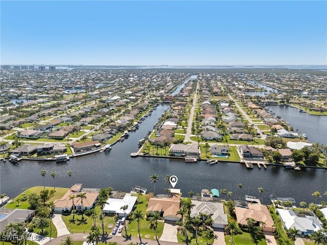 birds eye view of property featuring a water view and a residential view