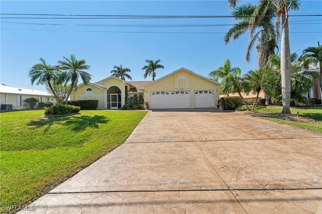 single story home with a front yard, driveway, an attached garage, and stucco siding