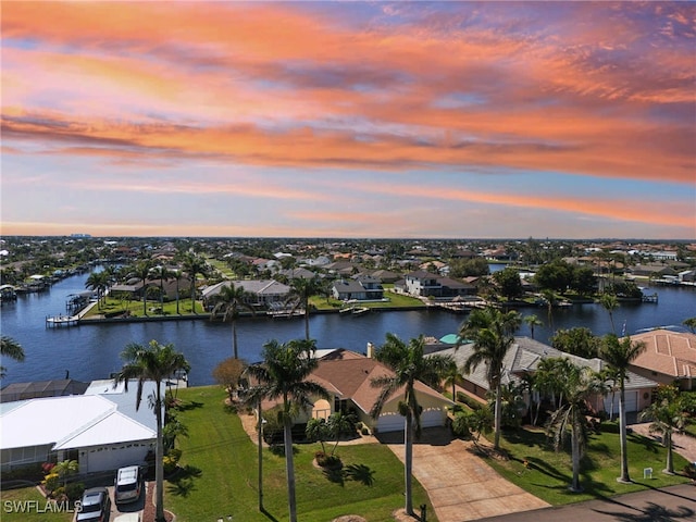 drone / aerial view with a water view and a residential view