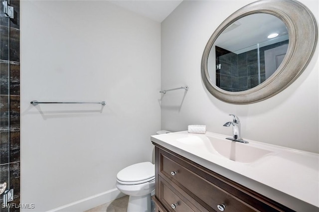 bathroom with vanity, toilet, and baseboards