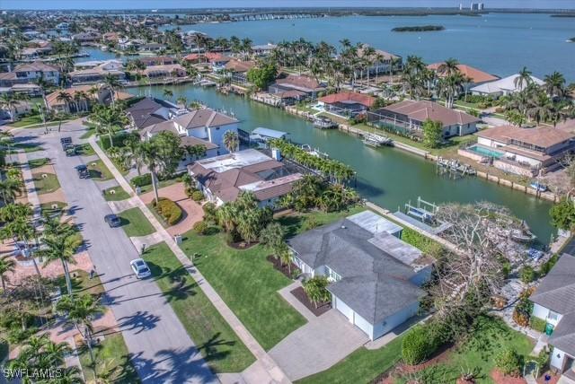 drone / aerial view with a water view and a residential view