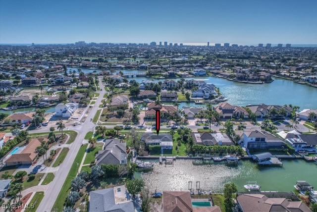 bird's eye view with a water view, a residential view, and a city view