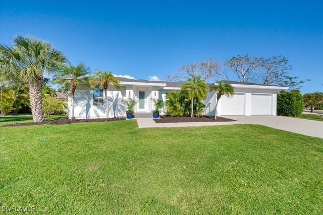 single story home featuring a garage, driveway, and a front lawn