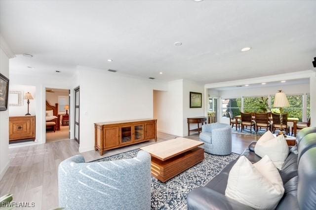 living area featuring visible vents, recessed lighting, a wealth of natural light, and light wood-style floors