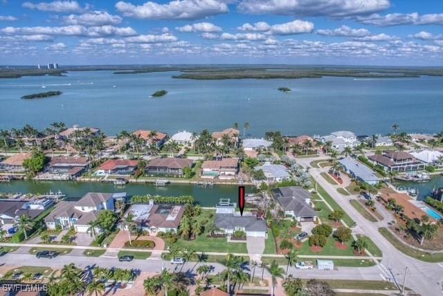 drone / aerial view with a residential view and a water view