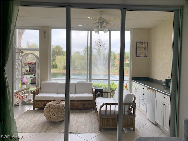 sunroom featuring ceiling fan and a wealth of natural light