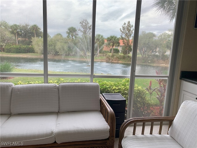 sunroom / solarium featuring a healthy amount of sunlight and a water view