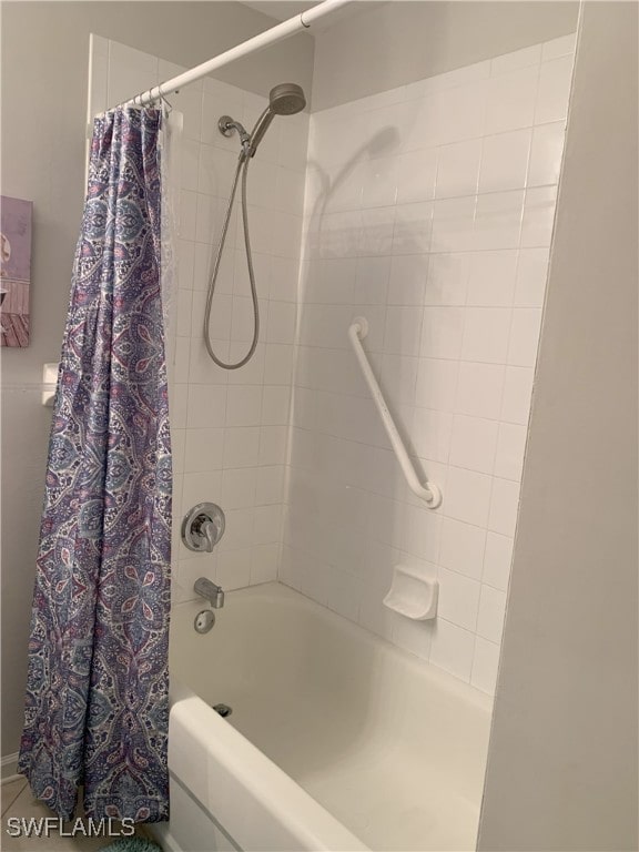 bathroom with shower / bath combo with shower curtain