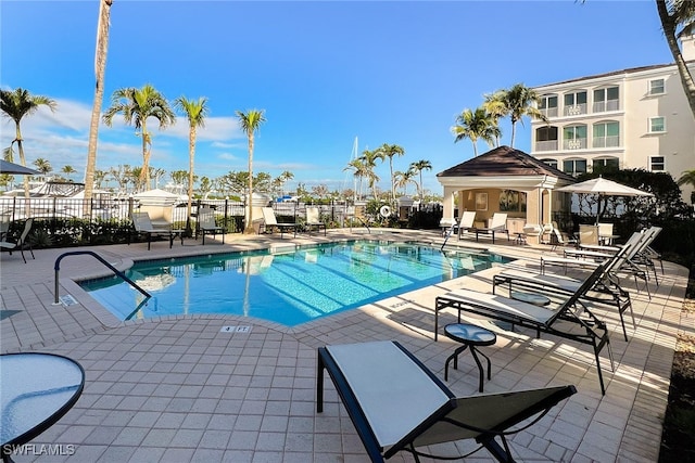 pool featuring a patio area and fence