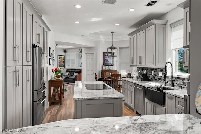 14328 Harbour Landings Dr Unit 18C, Fort Myers, FL 33908 - kitchen with gray cabinets, stainless steel appliances, light stone countertops, light wood-type flooring, and ornamental molding