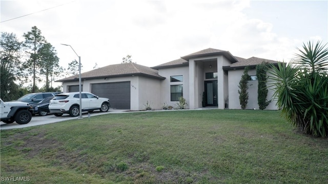 prairie-style house with an attached garage, driveway, a front lawn, and stucco siding