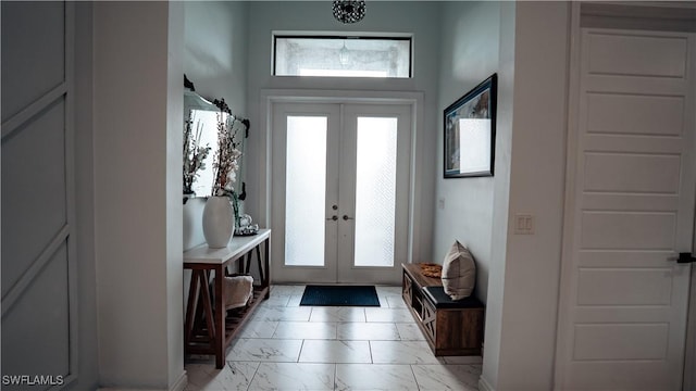 mudroom featuring marble finish floor, french doors, and a wealth of natural light